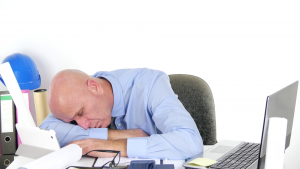 A picture of a person asleep on a desk